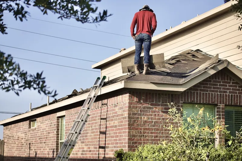 Professional roofer working on a residential roof in Bedford Springs